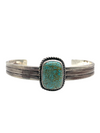 Cuff with 2 bar half round with 5/8" x 7/8" rectangular shaped genuine turquoise stone channel inlay with and peyote button in satin finish.Cuff measures 5" with 1 1/4" opening.Native American made.